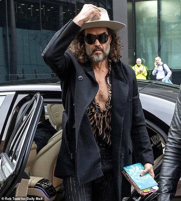 Russell Brand Arrives at Court for Rape Charges in Dramatic Attire and Bible Incident