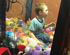Boy Traps Himself in Claw Machine During Attempt to Retrieve Prize, Sparks Panic